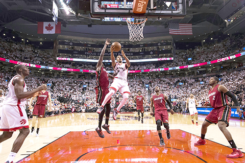 Toronto Raptors' guard Kyle Lowry (7) drives past Miami Heat forward Luol Deng (9) during the second half of Game 7 of the NBA basketball Eastern Conference semifinals in Toronto, Sunday, May 15, 2016. The Raptors won 116-89. (Nathan Denette/The Canadian Press via AP) MANDATORY CREDIT