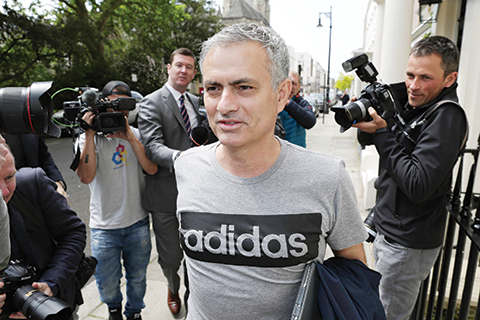 Media reporters surround footbal manager Jose Mourinho as he leaves his house in central London, Friday, May 27, 2016. Manchester United hired Jose Mourinho as its third manager in three years on Friday, entrusting the highly successful Portuguese coach with the job of restoring the status of England's most prestigious club. (Daniel Leal-Olivas/PA via AP) UNITED KINGDOM OUT  NO SALES NO ARCHIVE