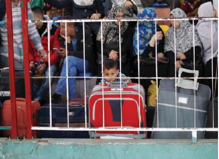 RAFAH, PALESTINIAN TERRITORIES: Palestinians wait at the Rafah border crossing with Egypt, in the southern Gaza Strip, after it was opened for two days by Egyptian authorities yesterday. —AFP
