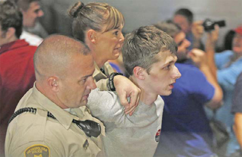 LAS VEGAS: In this June 18, 2016 file photo, police remove protestor Michael Steven Sandford as Republican presidential candidate Donald Trump speaks at the Treasure Island hotel and casino. — AP