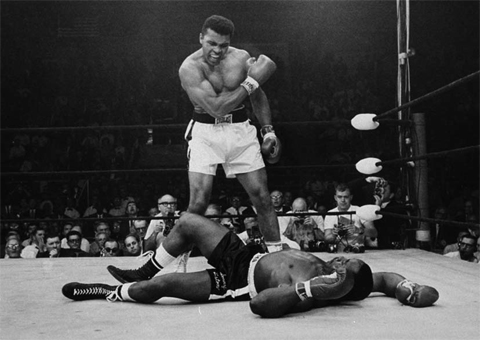 n this May 25, 1965 file photo, Heavyweight champion Muhammad Ali stands over fallen challenger Sonny Liston, shouting and gesturing shortly after dropping Liston with a short hard right to the jaw in Lewiston, Maine. — AP