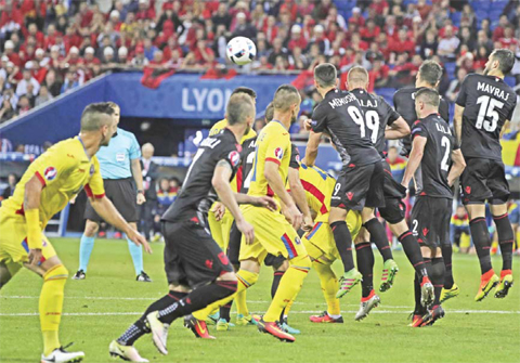 DECINES-CHARPIEU: Albanian players deflect a free kick during the Euro 2016 Group A soccer match between Romania and Albania at the Grand Stade in Decines-Charpieu, near Lyon, France, Sunday. — AP
