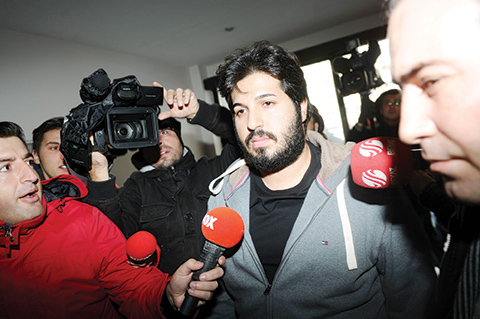 (FILES) This file photo taken on December 17, 2013 shows businessman Reza Zarrab (C)  surrounded by journalists as he arrives at a police center in Istanbul. nShould a Turkish gold mogul, arrested en route to Disney World with his superstar singer wife and five-year-old daughter, be released on a $50 million bond with armed security guards in a lavish Manhattan apartment?That is the question a US federal judge is pondering with respect to 33-year-old Iranian-Turkish businessman Reza Zarrab, charged with conspiring to violate international sanctions on Iran. Arrested in Miami in March, Zarrab on June 2, 2016 stepped into the glare of a New York court to attend a more than two-hour hearing that could determine whether he can swap jail for a fancy New York apartment in the sky.n / AFP PHOTO / OZAN KOSE
