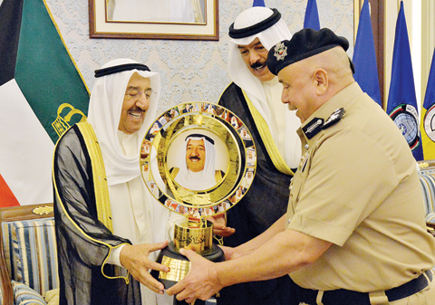 The Interior Ministry’s Undersecretary Lieutenant General Sulaiman Al-Fahad presents a memento to His Highness the Amir Sheikh Sabah Al-Ahmad Al-Jaber Al-Sabah