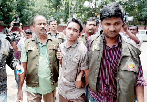 DHAKA: Members of Bangladesh Police Detective Branch escort Mohammed Sumon Hossain yesterday. — AP