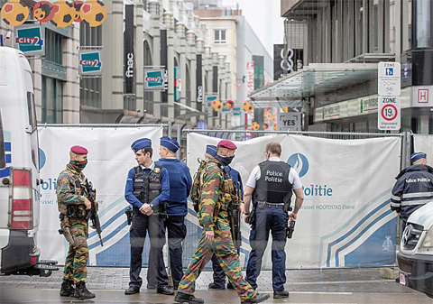 BRUSSELS: Belgian Army soldiers and Belgian police secure a scene after a bomb alert on a major shopping street yesterday. —AP