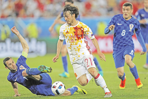 BORDEAUX: Croatia’s Darijo Srna, left, tackles Spain’s David Silva during the Euro 2016 Group D soccer match between Croatia and Spain at the Nouveau Stade in Bordeaux, France, Tuesday. — AP