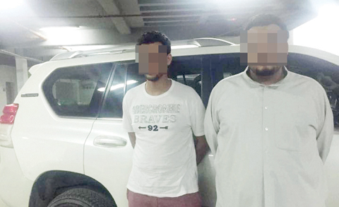 A photo provided by the Interior Ministry showing two suspects arrested for committing robberies while impersonating police.