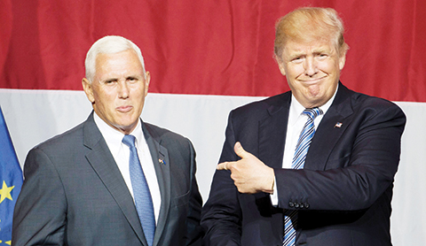 (FILES) This file photo taken on July 12, 2016 shows nUS Republican presidential candidate Donald Trump (R) and Indiana Governor Mike Pence (L) taking the stage during a campaign rally at Grant Park Event Center in Westfield, Indiana.nTrump named Pence as his vice presidential running mate, on July 15, 2016. / AFP PHOTO / Tasos KATOPODIS