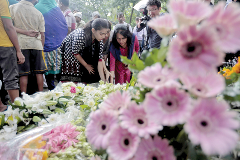 DHAKA: People offer flowers to pay their respects to the victims of the attack on Holey Artisan Bakery yesterday. —AP