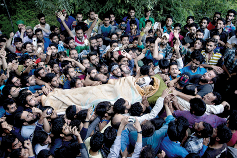 SRINAGAR: Kashmiri villagers carry body of Burhan Wani, chief of operations of Indian Kashmir’s largest rebel group Hizbul Mujahideen, during his funeral procession in Tral. —AP