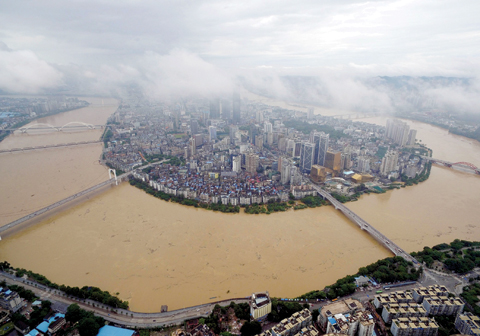 LIUZHOU, China: A general view shows the swollen Liujiang River in south China’s Guangxi Zhuang Autonomous Region yesterday. — AFP