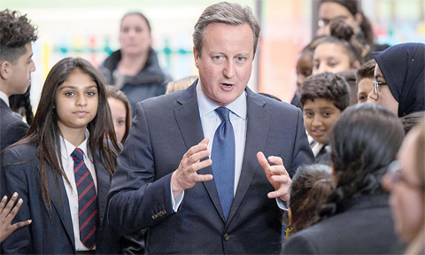 LONDON: Britain’s Prime Minister David Cameron is pictured during a visit to Reach Academy Feltham yesterday. —AP