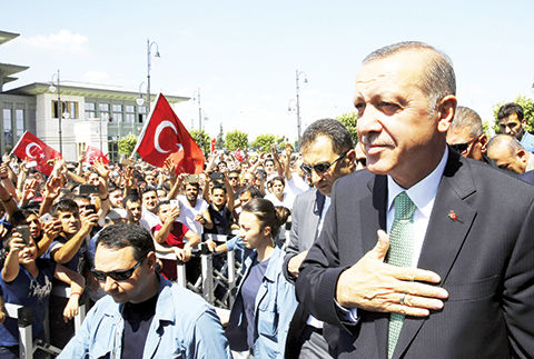 In this Friday, July 22, 2016 photo, Turkey's President Recep Tayyip Erdogan, acknowledges the crowd as he arrives at the parliament in Ankara, Turkey. Turkish lawmakers approved a three-month state of emergency that allows the government to extend detention times and issue decrees without parliamentary approval. (Press Presidency Press Service via AP, Pool)