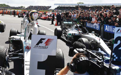 SILVERSTONE: Mercedes AMG Petronas F1 Team’s British driver Lewis Hamilton celebrates winning the British Formula One Grand Prix at Silverstone motor racing circuit in Silverstone, central England, on Sunday. — AFP