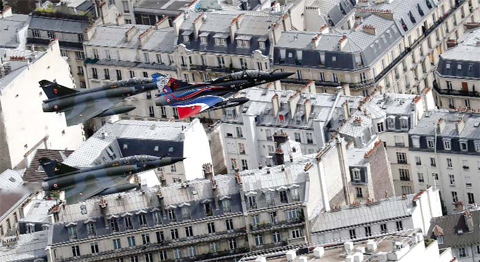 PARIS: A view taken from a helicopter shows three Mirage 2000N jets from the ‘La Fayette’ Escadrille, flying over the rooftops of Paris during the annual Bastille Day military parade on the Champs-Elysees avenue yesterday. —AFP