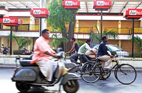AHMADABAD: In this Thursday, March 25, 2010, file photo, commuters go past hoardings of Bharti Airtel on a street in Ahmadabad. – AP 