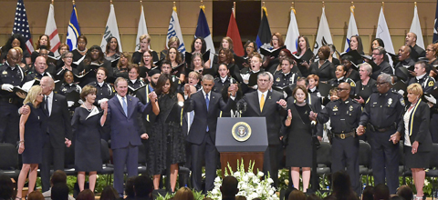 DALLAS: Dignitaries including US President Barack Obama and former president George W Bush join hands onstage during the singing of “The Battle Hymn of the Republic” during an interfaith memorial service for the victims of the Dallas police shooting at the Morton H Meyerson Symphony Center on Tuesday. — AFP