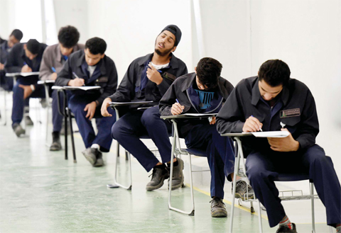 RIYADH: Saudi students pass their final exams at a workshop in the Higher Institute for Plastics Fabrication yesterday in Riyadh. — AFP