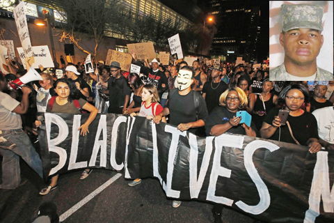 PHOENIX: Marchers take to the streets to protest against the recent fatal shootings of black men by police on Friday. (Inset) This undated handout photo shows Micah Xavier Johnson, the gunman who killed five officers in an ambush in Dallas. - AP/AFP