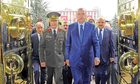 ANKARA: Turkey’s President Recep Tayyip Erdogan, right, and Turkey’s Chief of Staff General Hulusi Akar, enter the military headquarters. — AP