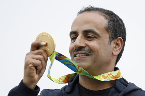 Fehaid Aldeehani, an independent athlete from Kuwait competing on the Refugee Olympic Team looks on his gold medal during the victory ceremony for the men's double trap event, at the Olympic Shooting Center at the 2016 Summer Olympics in Rio de Janeiro, Brazil, Wednesday, Aug. 10, 2016. (AP Photo/Hassan Ammar)