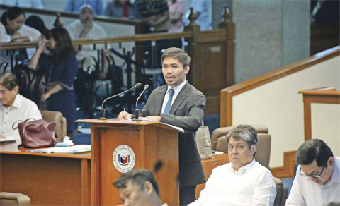 MANILA: Philippine boxing icon-turned-senator Manny Pacquiao delivers his privilege speech on restoration of the death penalty during a session at the senate in Manila yesterday. — AFP