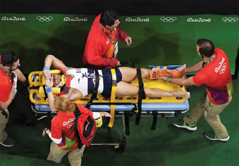 RIO DE JANEIRO: An overview shows France’s Samir Ait Said being stretchered off after being injured while competing in the qualifying for the men’s vault event of the Artistic Gymnastics at the Olympic Arena during the Rio 2016 Olympic Games in Rio de Janeiro on Saturday. — AFP
