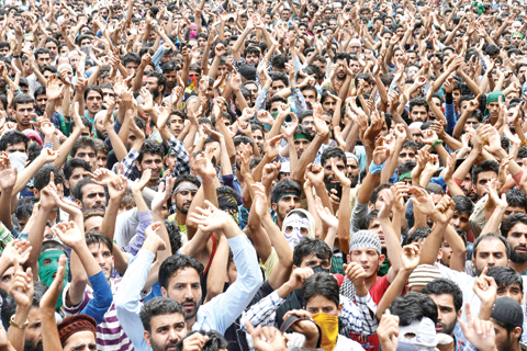 KASHMIR: Kashmiri mourners shout anti-Indian and pro-freedom slogans during the funeral of four civilians at Aripanthan Magam village in Budgam district on the outskirts of Srinagar yesterday. — AFP