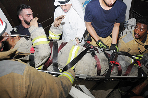 KUWAIT: A fireman is stretchered out of the scene after suffering an injury while tackling a blaze in Hawally.