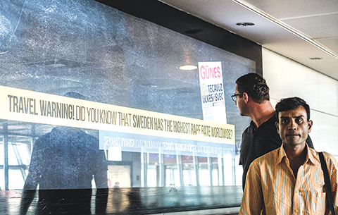 A passenger looks around to read a billboard that reads, 'Travel warning - Do you know that Sweden has the highest rape rate worldwide?' with an enlarged copy of the front page of pro-government newspaper Gunes with the headline saying 'Sweden, a country of rape', at the departures area of the Istanbul Ataturk International airport on August 19, 2016.   The billboard advertisement accusing Sweden of having 'the highest rape rate worldwide' comes just days after Stockholm accused Ankara of legalising sex with children. The advert was largely seen as a tit-for-tat move after Swedish Foreign Minister Margot Wallstrom caused a storm after writing a tweet which said the 