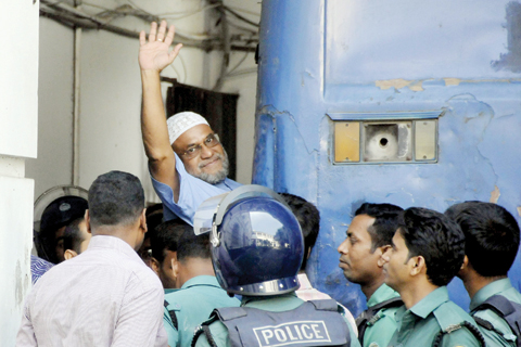 DHAKA: File photo shows Bangladeshi Jamaat-e-Islami party leader, Mir Quasem Ali waving as he enters a van at the International Crimes Tribunal court in Dhaka. A wealthy tycoon who was a chief financier for Bangladesh’s largest Islamist party could be executed in days after losing his final appeal yesterday, against a death sentence from a controversial war crimes tribunal. — AFP