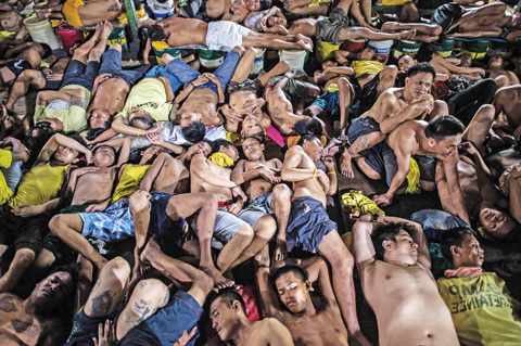 MANILA: Inmates sleep inside the Quezon City jail in Manila. — AFP photos