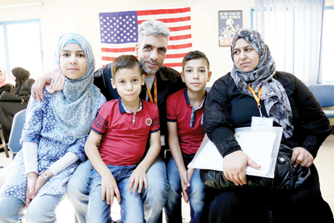 AMMAN: In this photo taken yesterday, five members of the Jouriyeh family, Syrian refugees headed to the US as part of a resettlement program, pose for a photo in the Amman, Jordan office of the International Organization for Migration. — A P