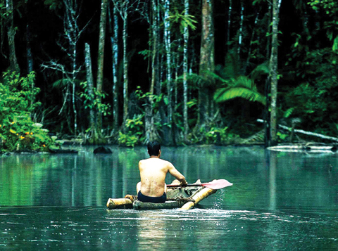 This image released by Yachaywasi Films shows Alberto Pizango, leader of Peru’s indigenous Amazonian people, rowing up the river in a scene from, ‘When Two Worlds Collide.’ — AP
