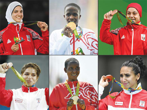 (COMBO) This combination of pictures taken during the Rio 2016 Olympic Games in Rio de Janeiro and created shows (from L-top to R-bottom) Egypt’s Hedaya Wahba (aka Hedaya Malek) with her bronze medal for the women’s taekwondo event in the -57kg category; Barhain’s Ruth Jebet with her gold medal for the Women’s 3000m Steeplechase in the athletics event; Egypt’s Sara Ahmed (aka Sarah Samir) with her bronze medal for the Women’s 69kg weightlifting event; Tunisia’s Marwa Amri with her bronze medal for the women’s 58kg freestyle wrestling even; Bahrain’s Eunice Jepkirui Kirwa with her silver medal for the Women’s Marathon in the athletics event and Tunisia’s Ines Boubakri with her bronze medal for the women’s individual foil fencing event. Six women from Arab countries won six medals, just two less than men, during the Rio 2016 Olympic Games in Rio de Janeiro. — AFP