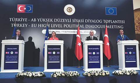 European Union's Foreign Policy Chief Federica Mogherini, second left, EU Enlargement Commissioner Johannes Hahn, left, Turkey's Foreign Minister Mevlut Cavusoglu, second right, and Turkey's EU Minister Omer Celik speak to the media after their talks in Ankara, Turkey, Friday, Sept. 9, 2016. Mogherini says the 28-member bloc and Turkey agree that there can be no military solution to the Syrian conflict and that only a political solution can bring peace to the war-torn country.(AP Photo/Burhan Ozbilici)