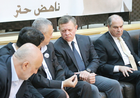 AMMAN: Jordanian King Abdullah II (2nd-R) and Prime Minister Hani Mulki (R) offering their condolences to relatives of Jordanian writer Nahed Hattar yesterday.—AFP