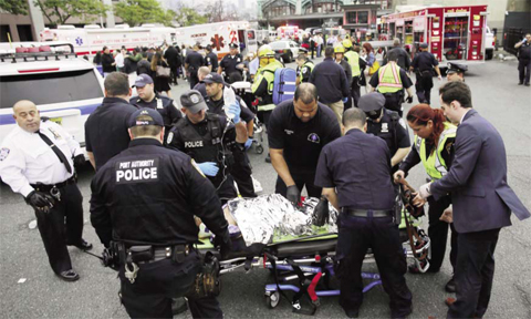 HOBOKEN, NEW JERSEY: First responders treat injured passengers after a New Jersey Transit train crashed into the platform at Hoboken Terminal during morning rush hour yesterday.—AFP