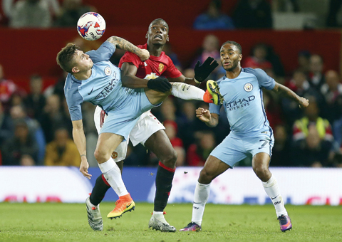 MANCHESTER: Manchester United’s Paul Pogba (centre) challenges for the ball with Manchester City’s Pablo Maffeo (left) and Manchester City’s Raheem Sterling during the English League Cup soccer match between Manchester United and Manchester City at Old Trafford stadium on Wednesday, Oct 26, 2016. — AP