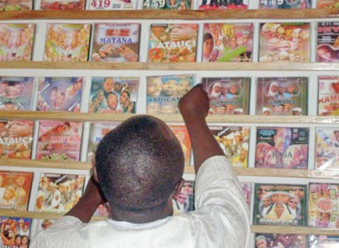 A customer searches for local Hausa films, known as Kannywood, popular among the residents of northern Nigeria’s city of Kano. — AFP