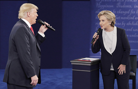 Republican presidential nominee Donald Trump and Democratic presidential nominee Hillary Clinton speak during the second presidential debate at Washington University in St Louis. —AP