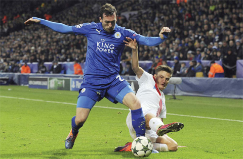 LEICESTER: Leicester’s Christian Fuchs, left, and Brugge’s Jelle Vossen challenge for the ball during the Champions League Group G soccer match between Leicester City and Club Brugge in Leicester, England, Tuesday. — AP