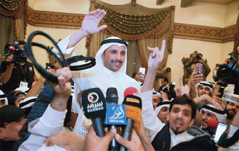 Former National Assembly speaker Marzouq Al-Ghanem celebrates with supporters in Abdullah Al-Salem following his victory in the parliamentary elections early today