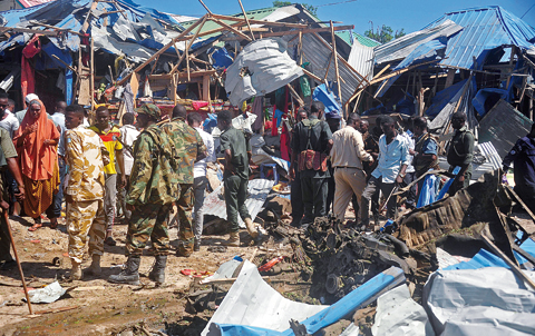 MOGADISHU: Security officers and military personnel secure yesterday the scene of a suicide car bomb attack in Somalia’s restive capital. —AFP