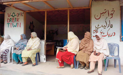 RAWALAKOT, Pakistan: In this photograph taken on November 21, 2016, Pakistani Kashmiri women wait outside the office of social worker Nusrat Yousuf to discuss their social issues with her in the women’s market on the outskirts of the town of Rawalakot, in Pakistani-administered Kashmir. — AFP