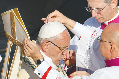 VATICAN CITY: Pope Francis (center) is helped to dress for the celebration of a mass marking the end of the Jubilee of Mercy in Vatican. — AFP