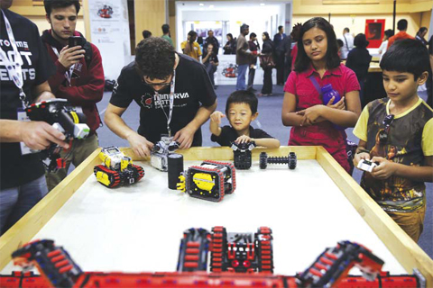 NEW DELHI: Participants and spectators watch robots displayed at the World Robot Olympiad in New Delhi, India. — AP