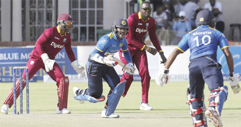 HARARE: Sri Lanka batsman Asela Gunaratne and Sachiti Pathirana make a run during the One Day cricket match against West Indies at Harare Sports Club in Harare, yesterday. The two teams are playing in a triangular series featuring Zimbabwe. —AP