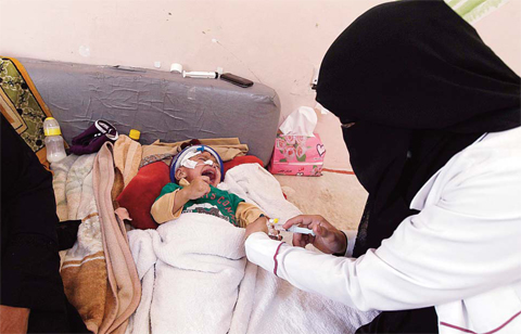 SANAA: A Yemeni doctor makes an injection to a baby at a Kuwaiti hospital in the Yemeni capital Sanaa. One and a half million children suffer from malnutrition, including 370,000 for whom it is so severe it weakens their immune system, the UN children’s agency says. —AFP
